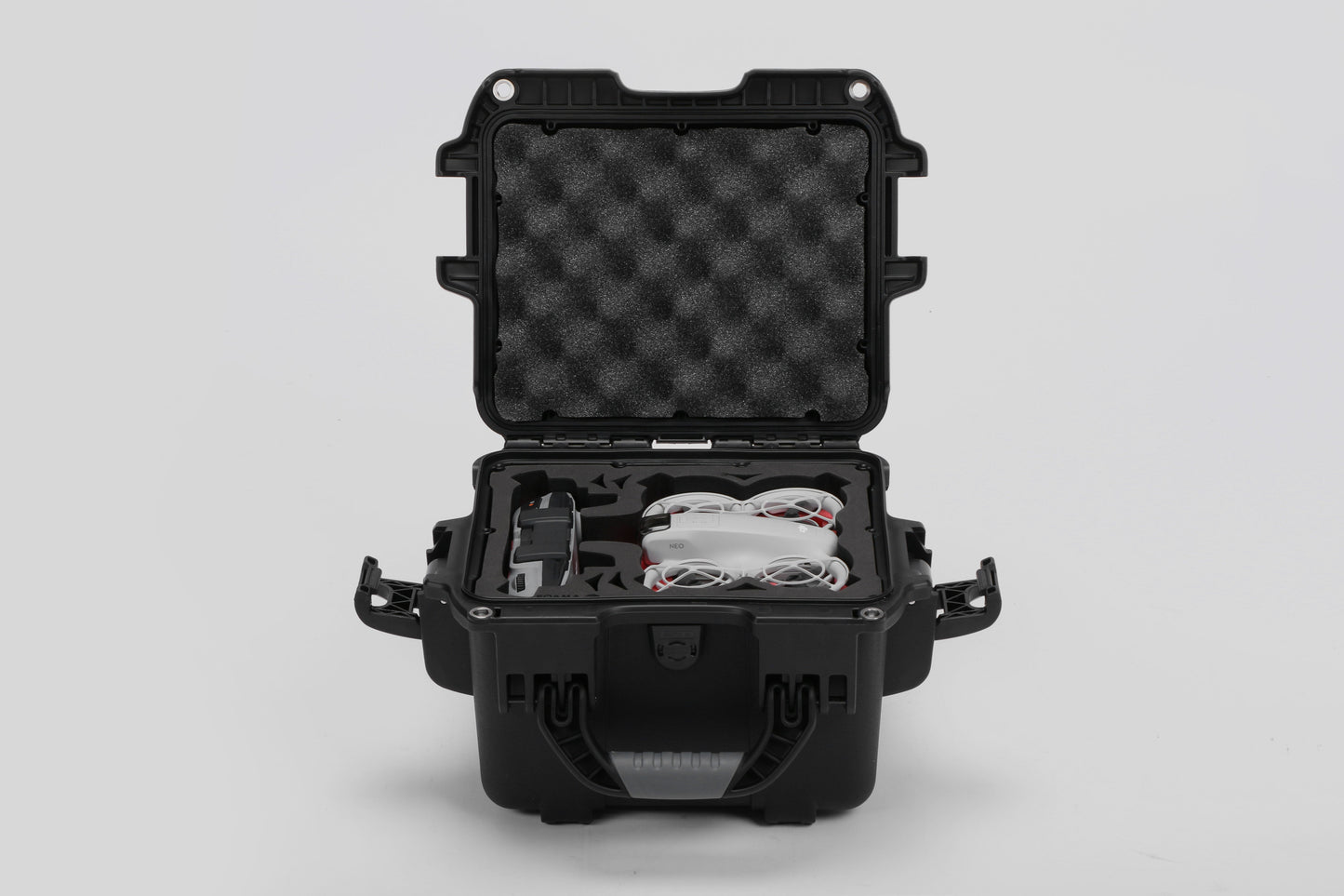 Front view of DJI Neo Black Color Adventure Ready Compact Waterproof Carry-on Case and Custom Foam Insert with a Red Layer, holding the DJI Neo Combo