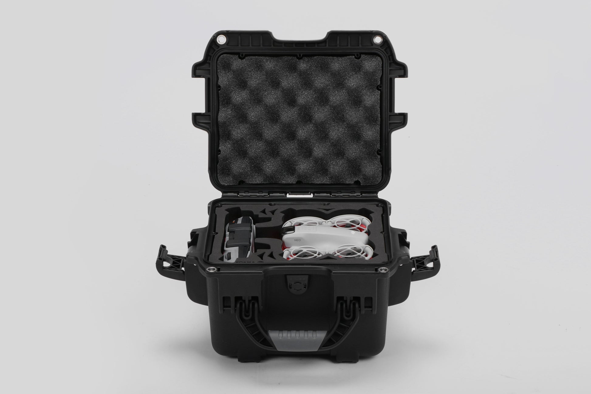 Front view of DJI Neo Black Color Adventure Ready Compact Waterproof Carry-on Case and Custom Foam Insert with a Red Layer, holding the DJI Neo Combo
