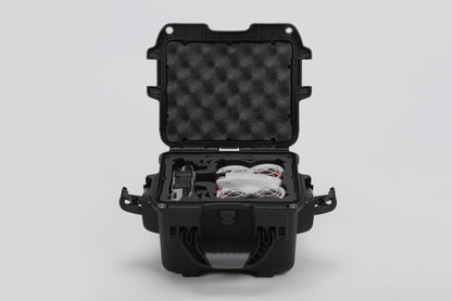 Front view of DJI Neo Black Color Adventure Ready Compact Waterproof Carry-on Case and Custom Foam Insert with a Red Layer, holding the DJI Neo Combo