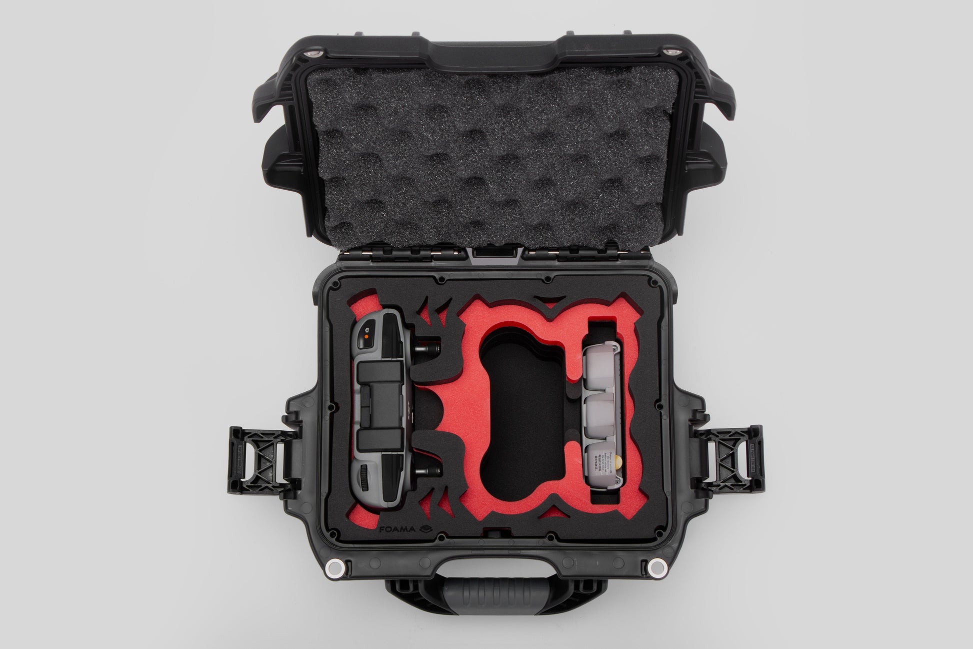 Top view of DJI Neo Black Color Adventure Ready Compact Waterproof Carry-on Case and Custom Foam Insert with a Red Layer, holding the DJI Neo Contoller and Batteries