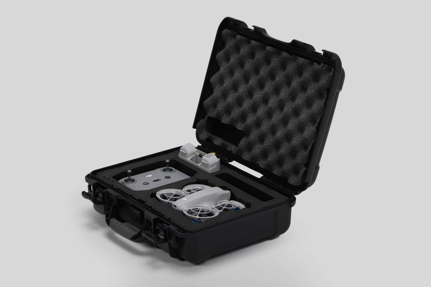 Angled view of Foama black all-weather carry-on case with stylish blue layer insert, holding DJI Neo