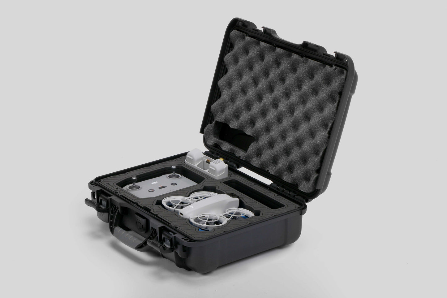 Angled view of Foama black all-weather carry-on case with stylish blue layer insert, holding DJI Neo