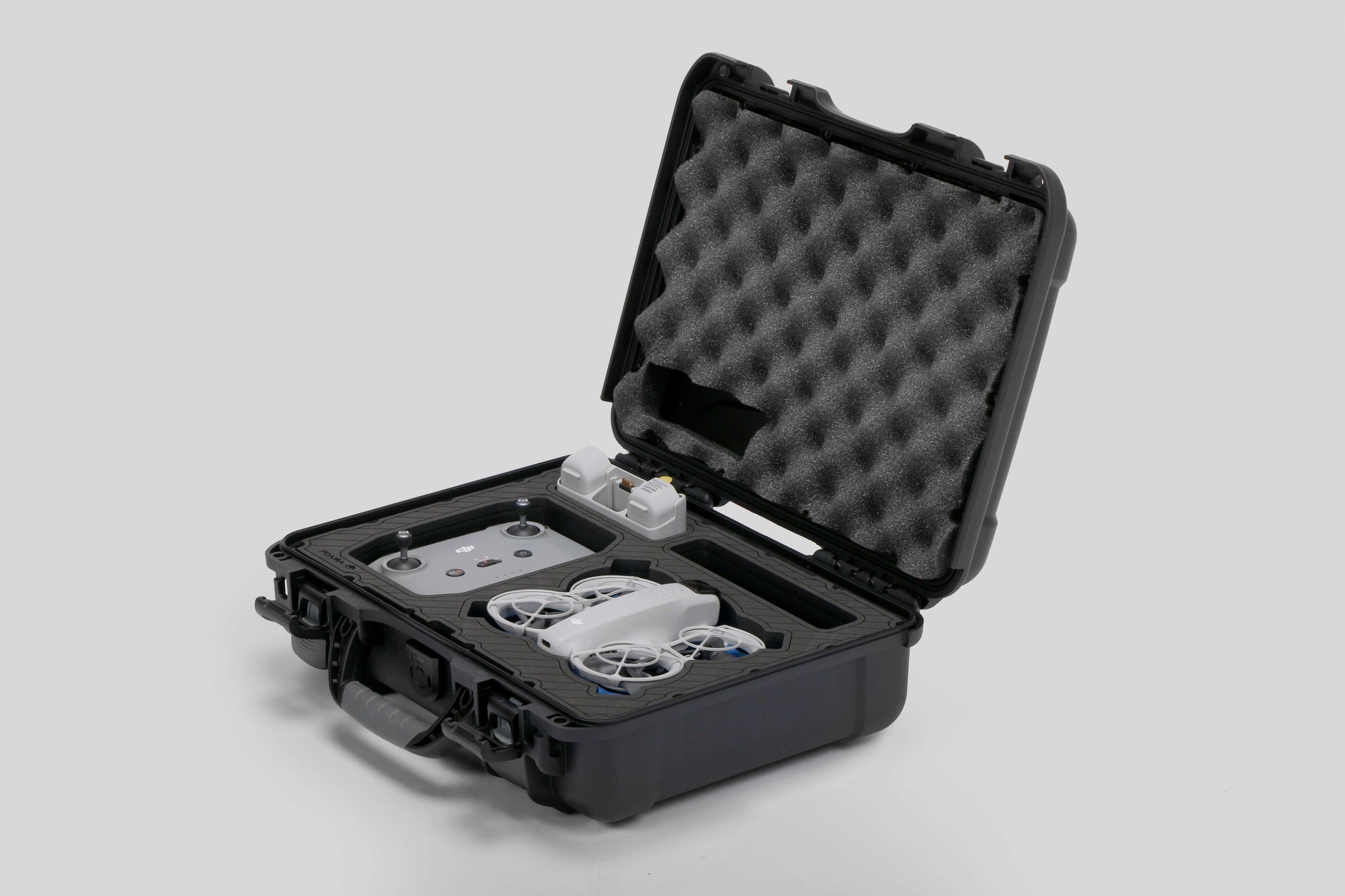 Angled view of Foama black all-weather carry-on case with stylish blue layer insert, holding DJI Neo
