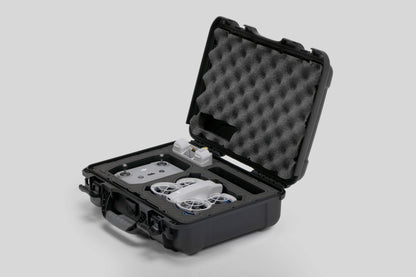 Angled view of Foama black all-weather carry-on case with stylish blue layer insert, holding DJI Neo