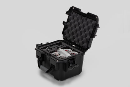 Angled view of DJI Neo Black Color Adventure Ready Compact Waterproof Carry-on Case and Custom Foam Insert with a Red Layer, holding the DJI Neo Combo