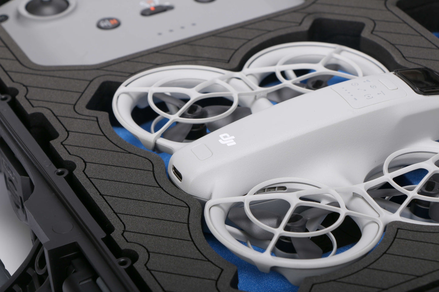 Close up view 1 of Foama black all-weather carry-on case with stylish blue layer insert, holding DJI Neo